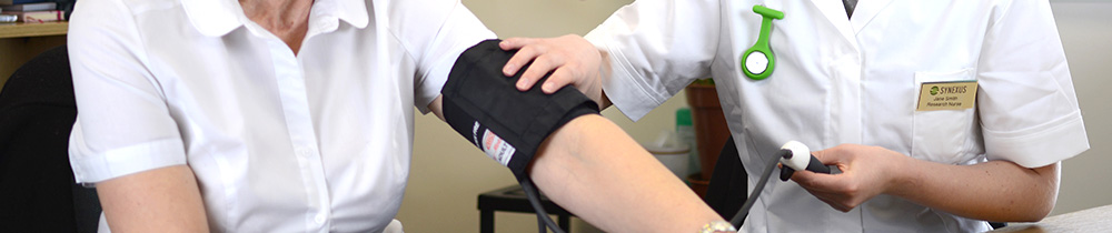 Nurse taking the blood pressure of her patient